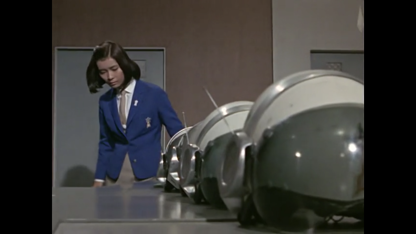 Akiko looking at the helmets